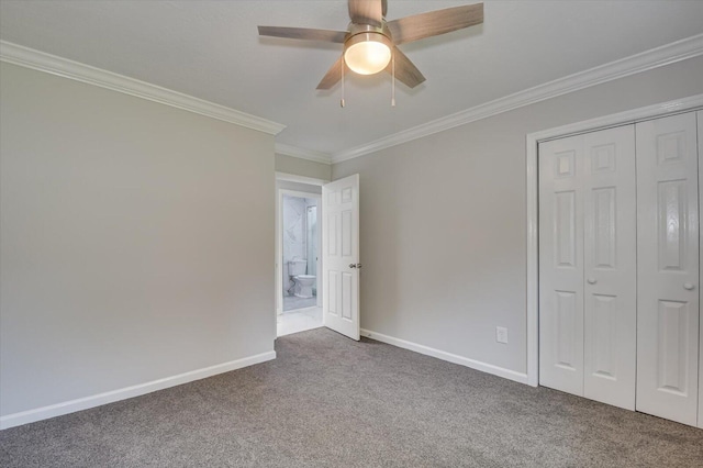 2417 Wilkshire Dr, Augusta, GA 30904 - unfurnished bedroom featuring a closet, baseboards, ornamental molding, a ceiling fan, and dark colored carpet