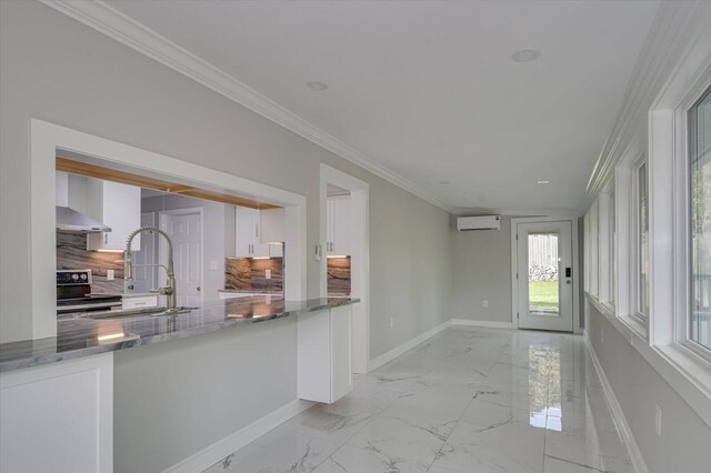 2417 Wilkshire Dr, Augusta, GA 30904 - interior space with white cabinetry, a wall unit AC, stainless steel electric range, baseboards, and marble finish floor