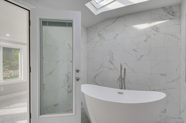 2417 Wilkshire Dr, Augusta, GA 30904 - bathroom featuring marble finish floor, a soaking tub, and a skylight