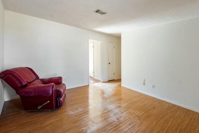 sitting room with wood-type flooring