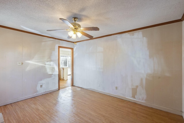 unfurnished room featuring ceiling fan, ornamental molding, a textured ceiling, and light wood-type flooring