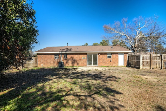 back of house with a lawn