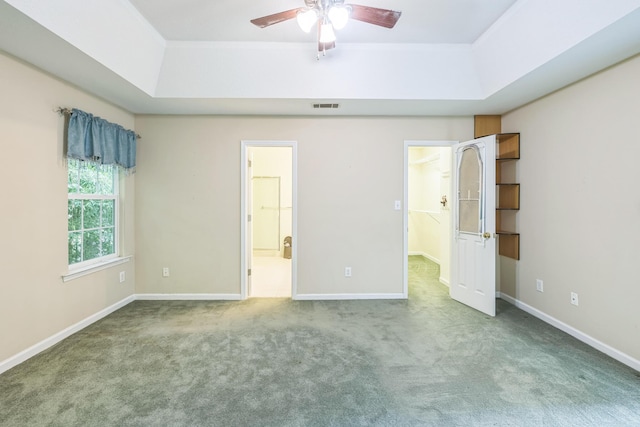 3758 Boulder Trl, Augusta, GA 30907 - unfurnished bedroom with a tray ceiling, carpet, connected bathroom, and ceiling fan