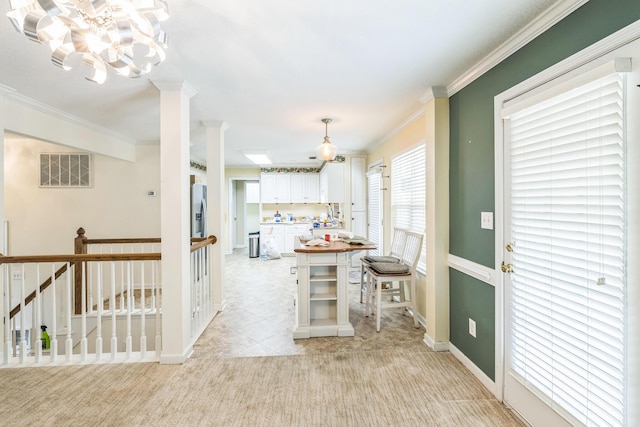 3758 Boulder Trl, Augusta, GA 30907 - kitchen with white cabinetry, crown molding, light colored carpet, a chandelier, and stainless steel fridge