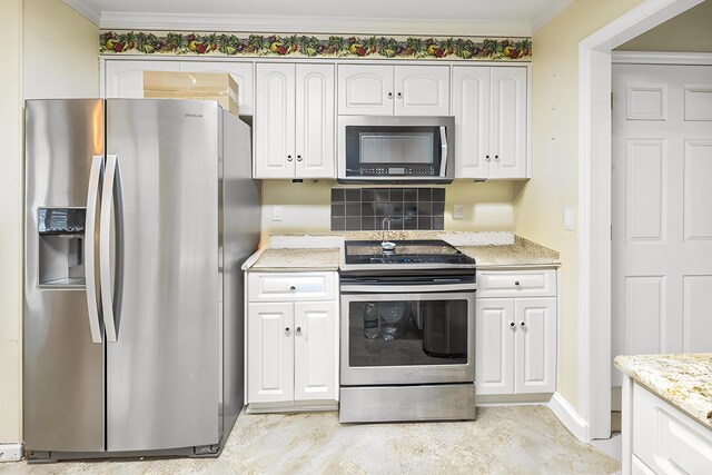 3758 Boulder Trl, Augusta, GA 30907 - kitchen with appliances with stainless steel finishes, white cabinets, light stone counters, and crown molding