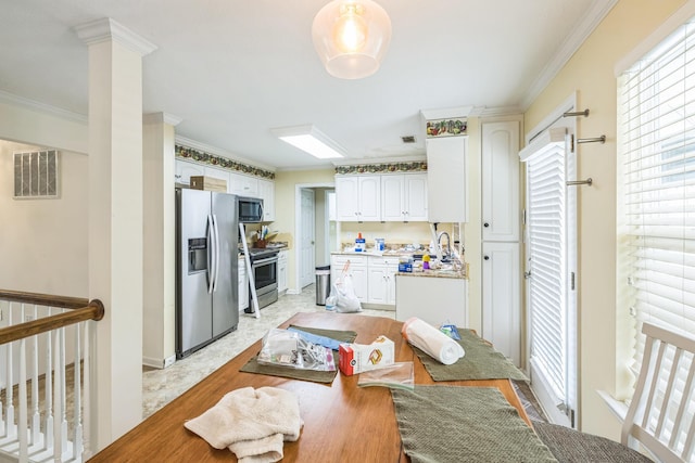 3758 Boulder Trl, Augusta, GA 30907 - kitchen featuring appliances with stainless steel finishes, crown molding, white cabinets, and light countertops