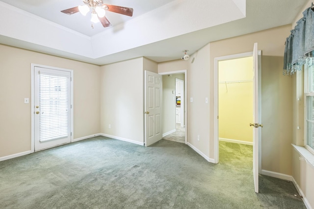 3758 Boulder Trl, Augusta, GA 30907 - unfurnished bedroom with carpet flooring, a walk in closet, a ceiling fan, and a tray ceiling