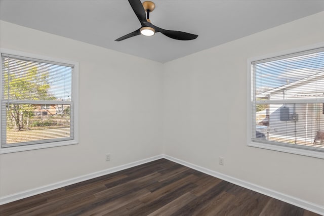 unfurnished room with plenty of natural light, ceiling fan, and dark hardwood / wood-style flooring