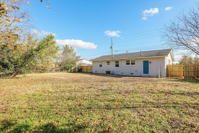 back of house featuring a yard and cooling unit