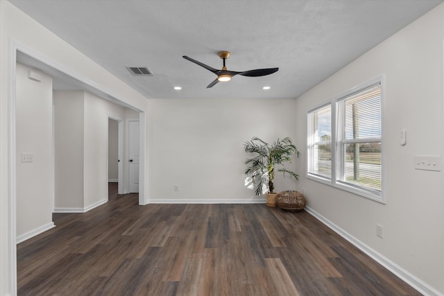 empty room featuring ceiling fan and dark hardwood / wood-style floors