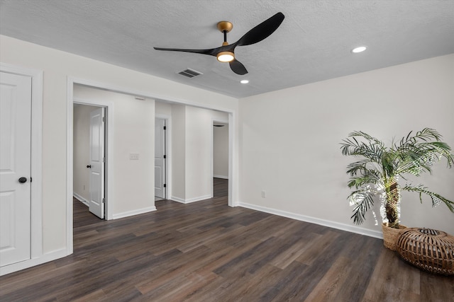 unfurnished bedroom featuring a textured ceiling, ceiling fan, and dark wood-type flooring