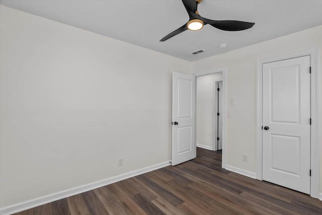 unfurnished bedroom with dark hardwood / wood-style floors and ceiling fan