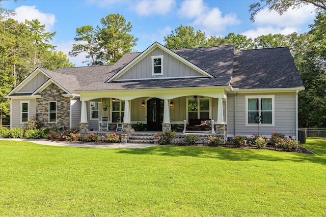 craftsman inspired home featuring covered porch and a front yard