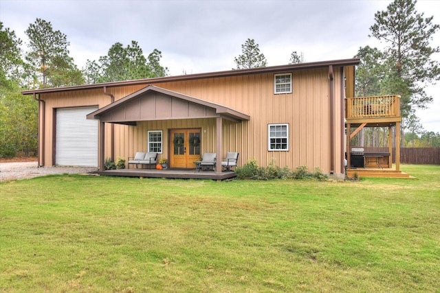 view of front facade featuring a wooden deck, french doors, and a front yard