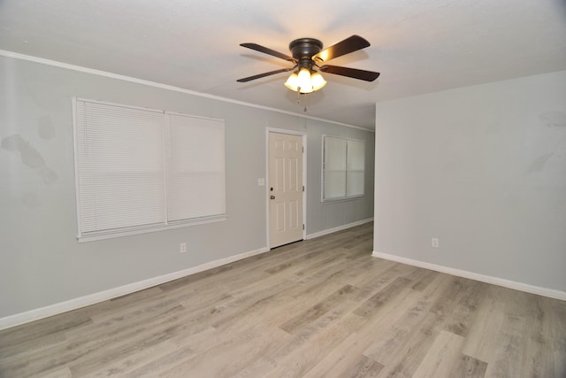 unfurnished room featuring ceiling fan, crown molding, and light hardwood / wood-style flooring