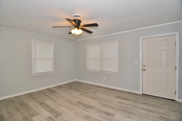 spare room with ceiling fan, light hardwood / wood-style flooring, and ornamental molding