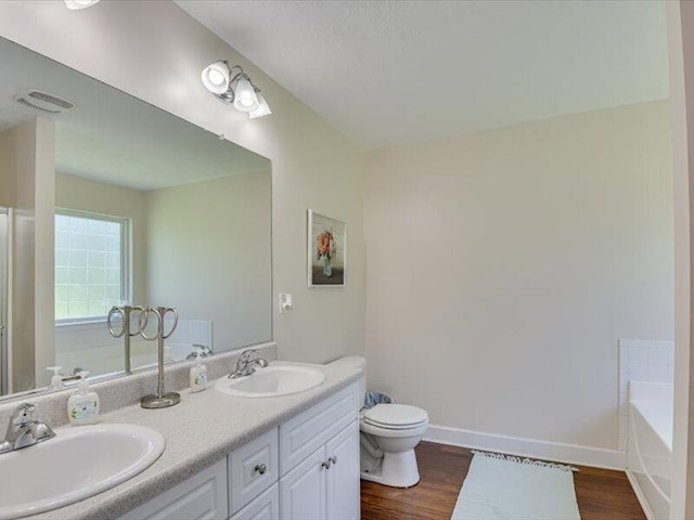 2084 Gardenview Dr, Graniteville, SC 29829 - bathroom with double vanity, a tub, and wood finished floors