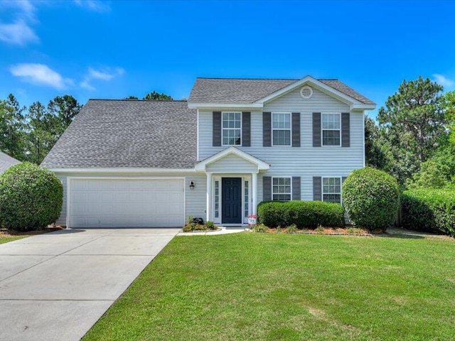 2084 Gardenview Dr, Graniteville, SC 29829 - colonial home with an attached garage, concrete driveway, a front lawn, and roof with shingles