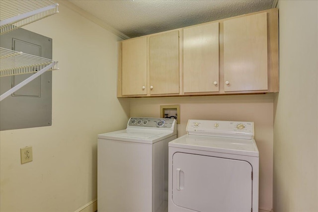 laundry area featuring cabinets, separate washer and dryer, and a textured ceiling