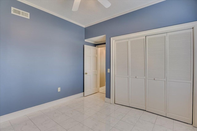 unfurnished bedroom with ceiling fan, ornamental molding, and a closet