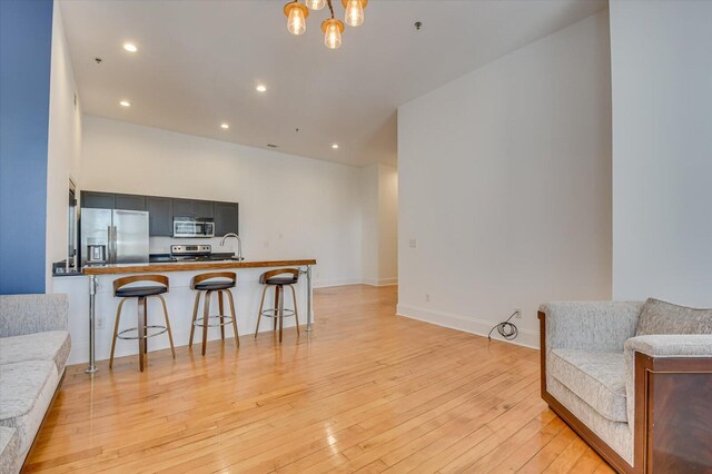 living room featuring sink and light hardwood / wood-style flooring