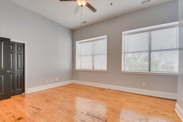 empty room featuring ceiling fan and light hardwood / wood-style flooring