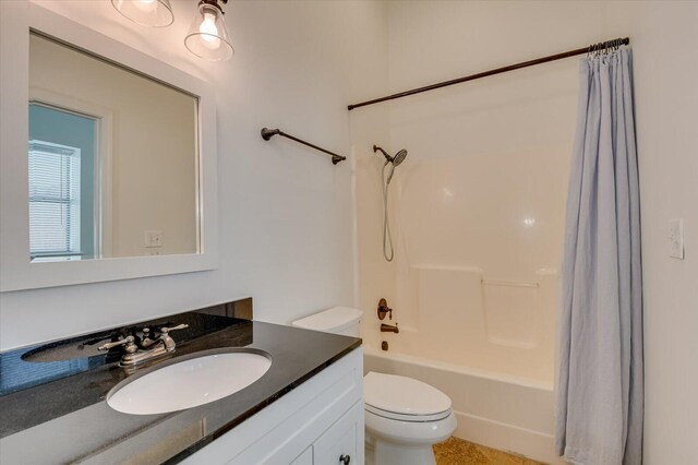 full bathroom with shower / bath combo, vanity, and toilet