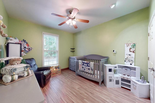 249 Calloway Dr, Evans, GA 30809 - bedroom with light wood-style floors, a nursery area, and a ceiling fan