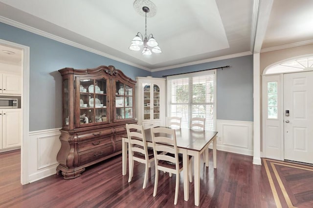 249 Calloway Dr, Evans, GA 30809 - dining area featuring a chandelier, dark wood-style floors, wainscoting, crown molding, and a decorative wall