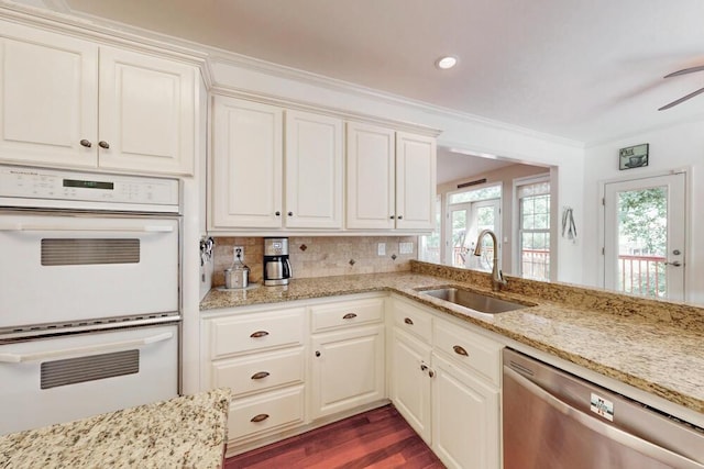 249 Calloway Dr, Evans, GA 30809 - kitchen with white double oven, stainless steel dishwasher, ceiling fan, dark wood finished floors, and decorative backsplash