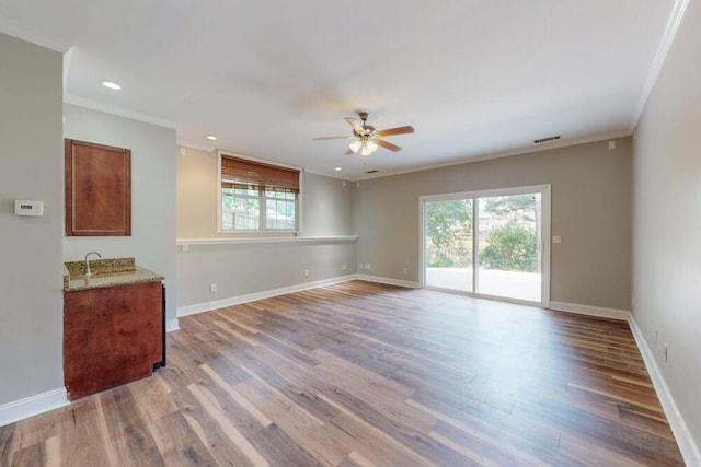 249 Calloway Dr, Evans, GA 30809 - unfurnished room with ceiling fan, plenty of natural light, ornamental molding, wood finished floors, and recessed lighting
