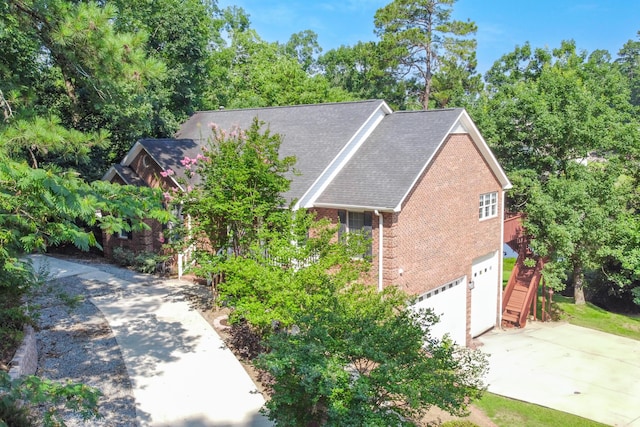 249 Calloway Dr, Evans, GA 30809 - view of property exterior with brick siding, an attached garage, driveway, and view of wooded area