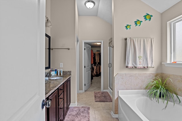 1610 Cedar Hill Dr, Grovetown, GA 30813 - bathroom featuring lofted ceiling, double vanity, a bath, a walk in closet, and a shower stall