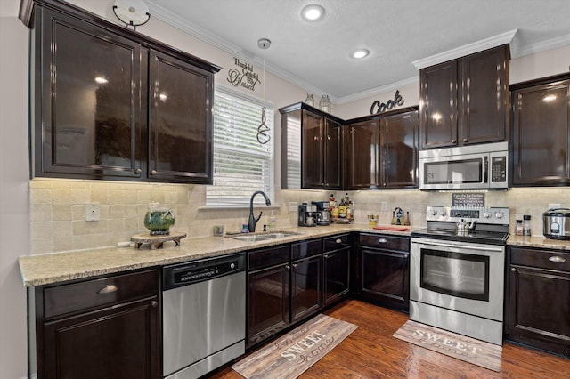 1610 Cedar Hill Dr, Grovetown, GA 30813 - kitchen with appliances with stainless steel finishes, dark wood-style floors, crown molding, dark brown cabinets, and backsplash