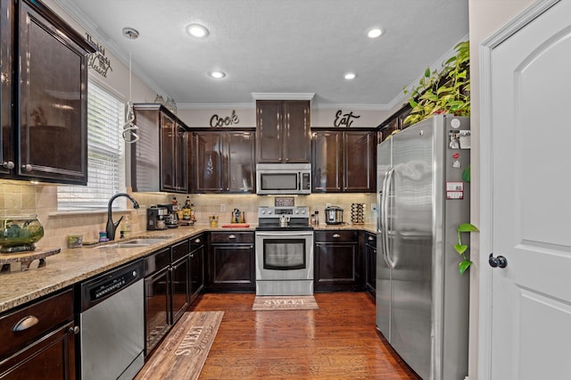 1610 Cedar Hill Dr, Grovetown, GA 30813 - kitchen featuring appliances with stainless steel finishes, crown molding, dark brown cabinetry, light stone counters, and decorative backsplash