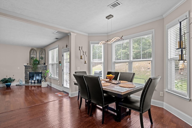 1610 Cedar Hill Dr, Grovetown, GA 30813 - dining space featuring wood-type flooring, a fireplace, a textured ceiling, and ornamental molding