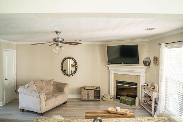 1410 Summit Way, Grovetown, GA 30813 - living area featuring ornamental molding, a tiled fireplace, ceiling fan, and wood finished floors