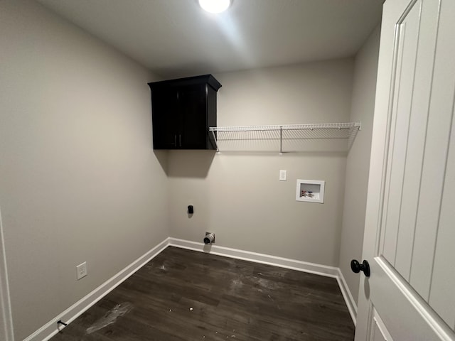 laundry area with washer hookup, dark hardwood / wood-style floors, and cabinets