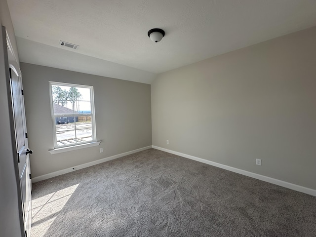 unfurnished room featuring light colored carpet and vaulted ceiling