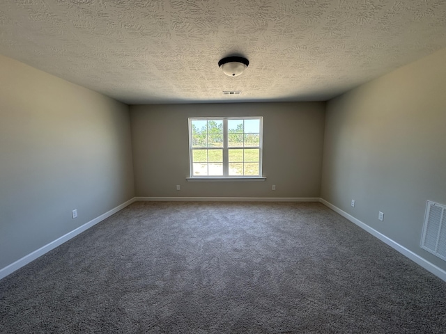 carpeted spare room with a textured ceiling