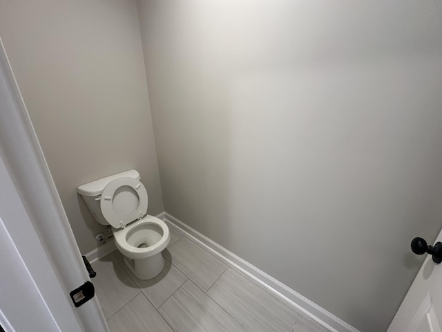 bathroom with tile patterned flooring and toilet