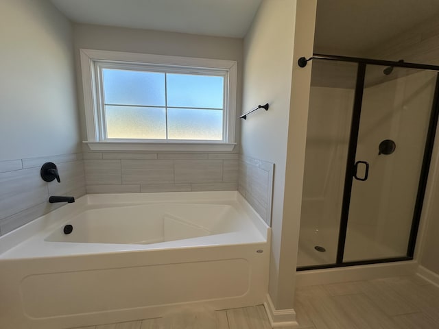 bathroom with separate shower and tub