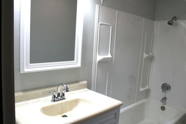 bathroom with shower / washtub combination and vanity