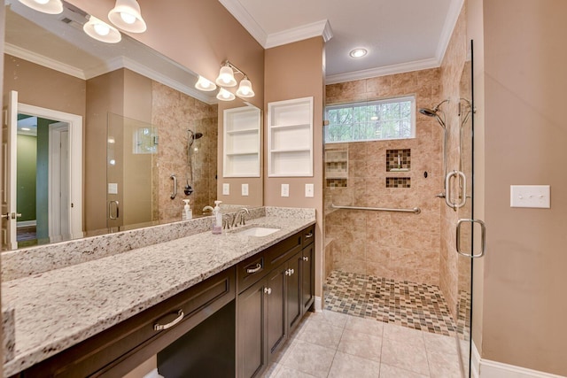 bathroom with tile patterned flooring, ornamental molding, vanity, and walk in shower