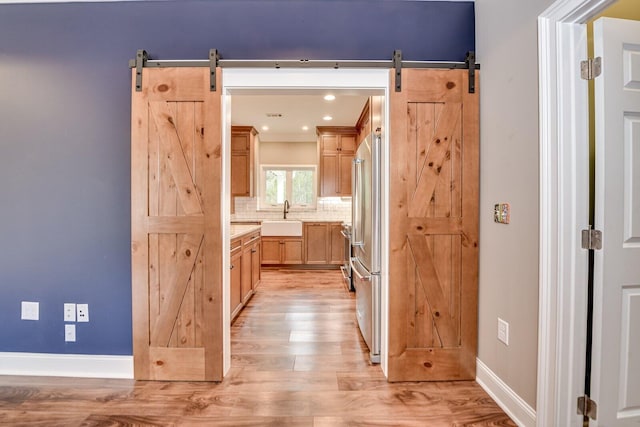 interior space with sink, hardwood / wood-style floors, and backsplash