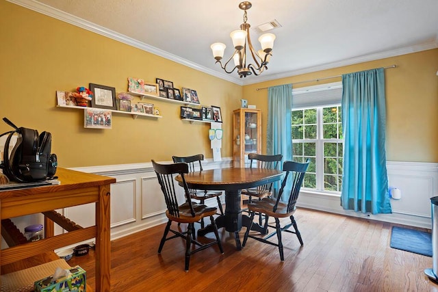 2009 Dundee Way, Grovetown, GA 30813 - dining room featuring a chandelier, ornamental molding, a wainscoted wall, wood finished floors, and a decorative wall