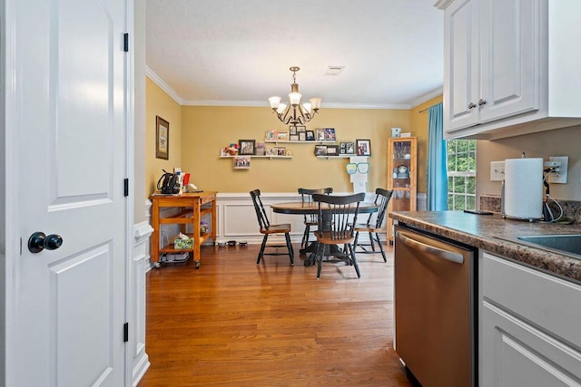 2009 Dundee Way, Grovetown, GA 30813 - dining area featuring a chandelier, ornamental molding, wood finished floors, and wainscoting