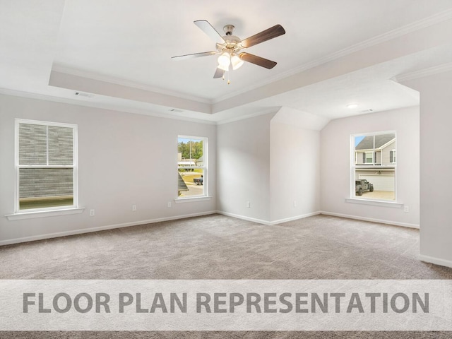 carpeted spare room featuring a raised ceiling, crown molding, and ceiling fan