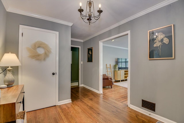 3122 Ramsgate Rd, Augusta, GA 30909 - hall featuring a chandelier, wood finished floors, and ornamental molding