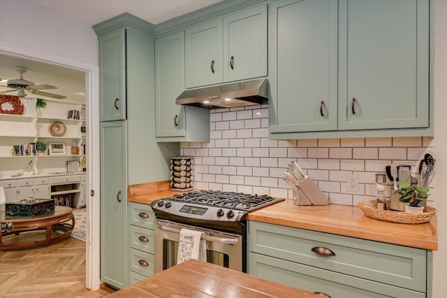 3122 Ramsgate Rd, Augusta, GA 30909 - kitchen featuring green cabinets, gas stove, under cabinet range hood, butcher block counters, and ceiling fan